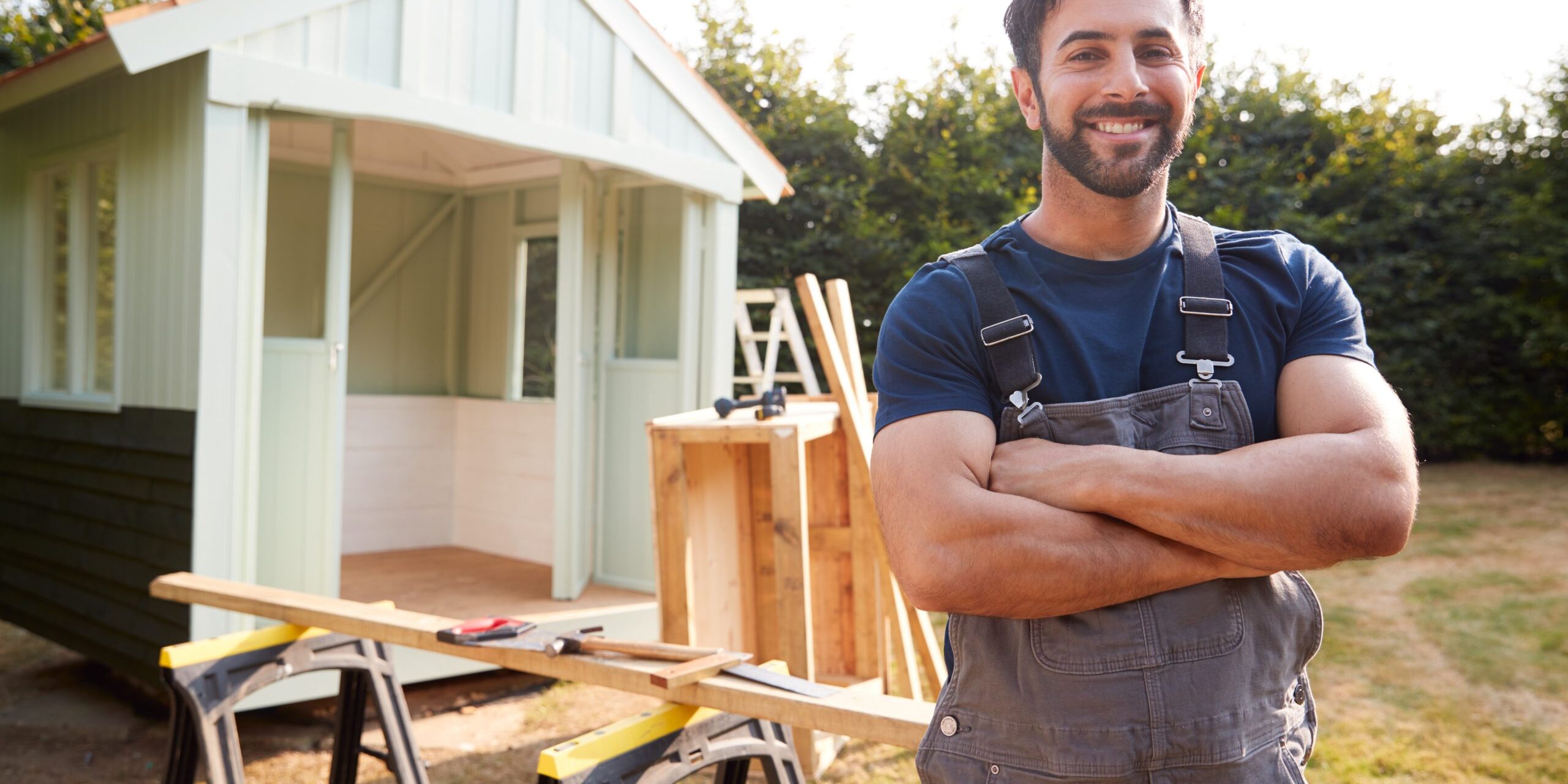 Portrait Of Male Carpenter Building Outdoor Summerhouse In Garden Custom Home Builder Fort Collins CO